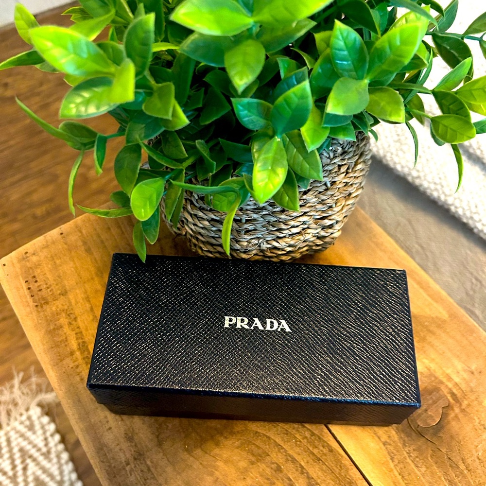 Prada sunglasses never worn.  To tight for my big head.